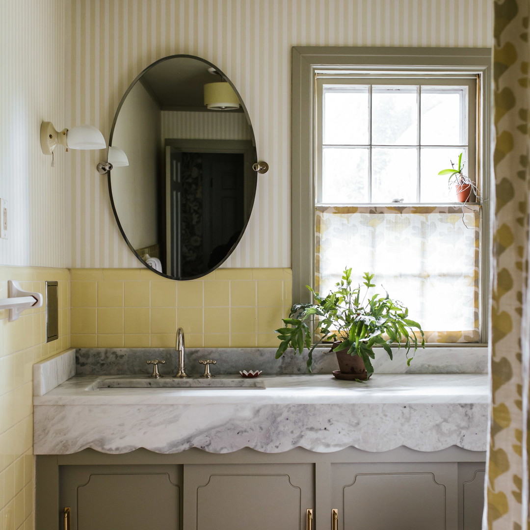 a bathroom with a sink, toilet and a mirror