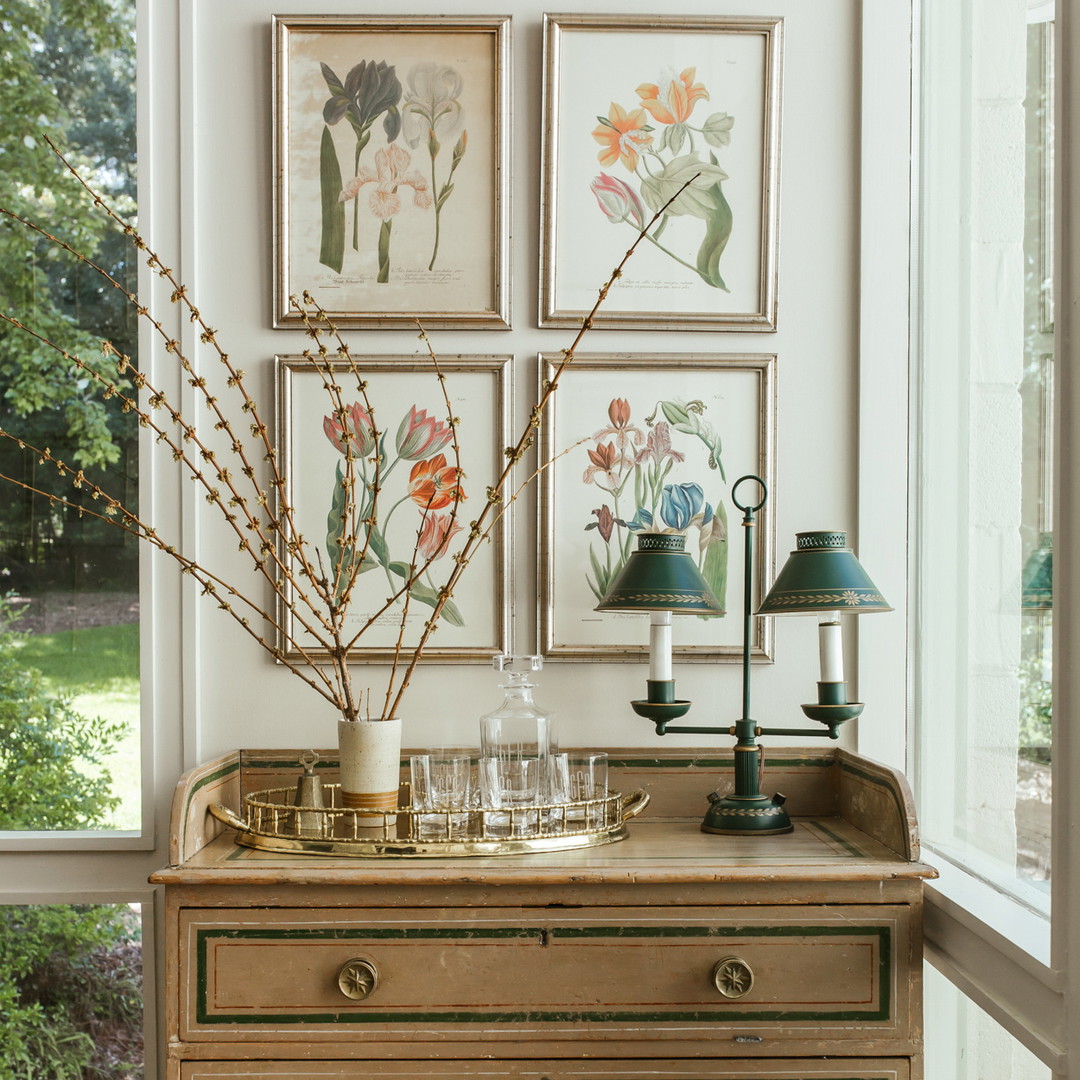 a dresser in a room with pictures on the wall