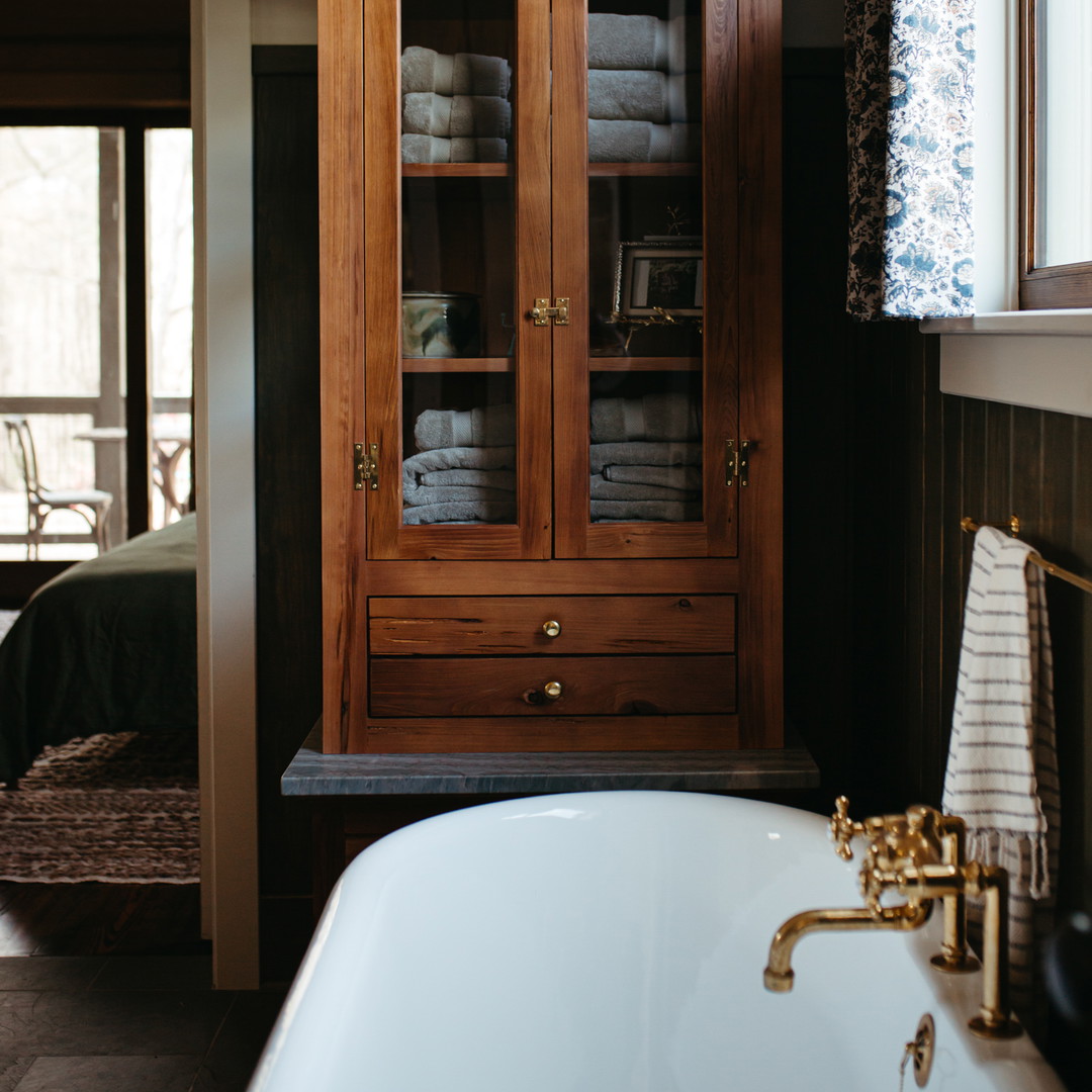 a bathroom with a tub and a cabinet in it