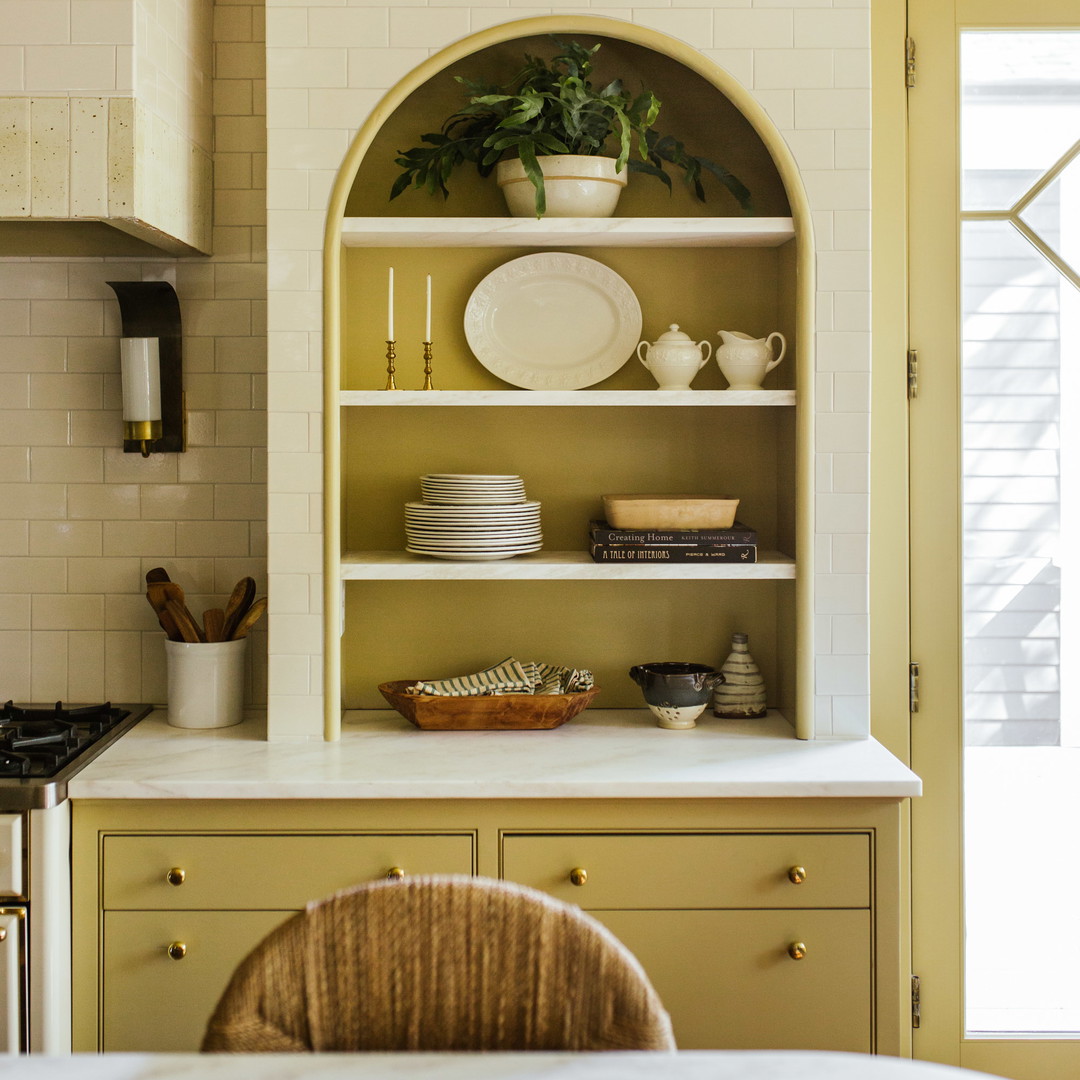 a kitchen with a white counter top next to a window