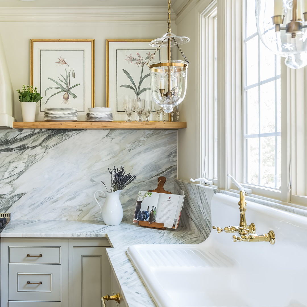 a kitchen with a marble counter top and white cabinets