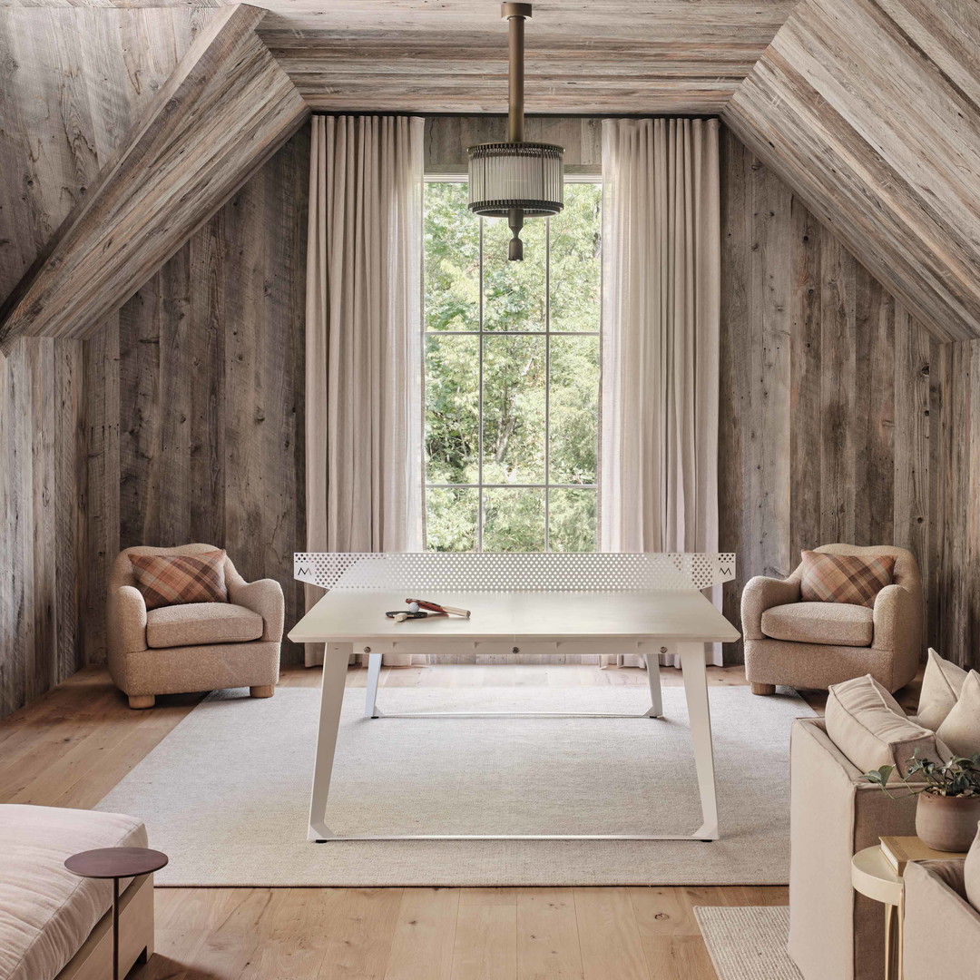 a living room filled with furniture and a white table