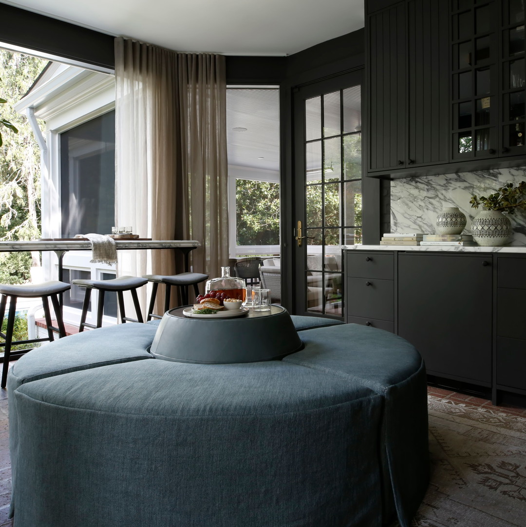 a living room filled with furniture and lots of windows