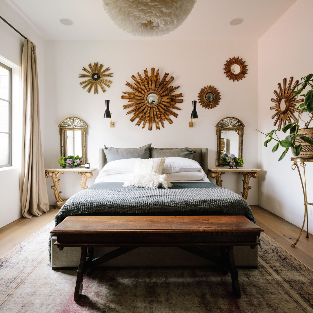 a bedroom with a large bed and a wooden bench