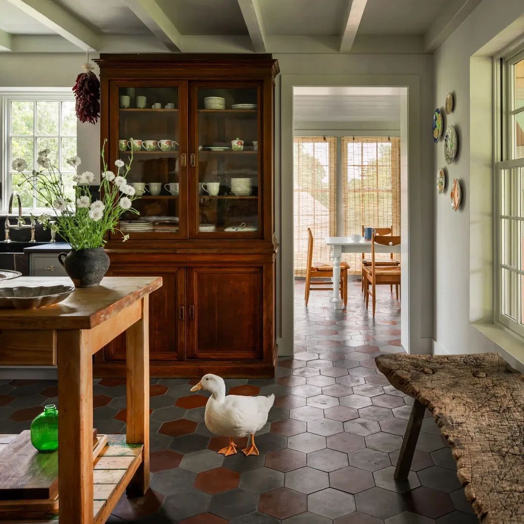 a wooden table sitting in a kitchen next to a window