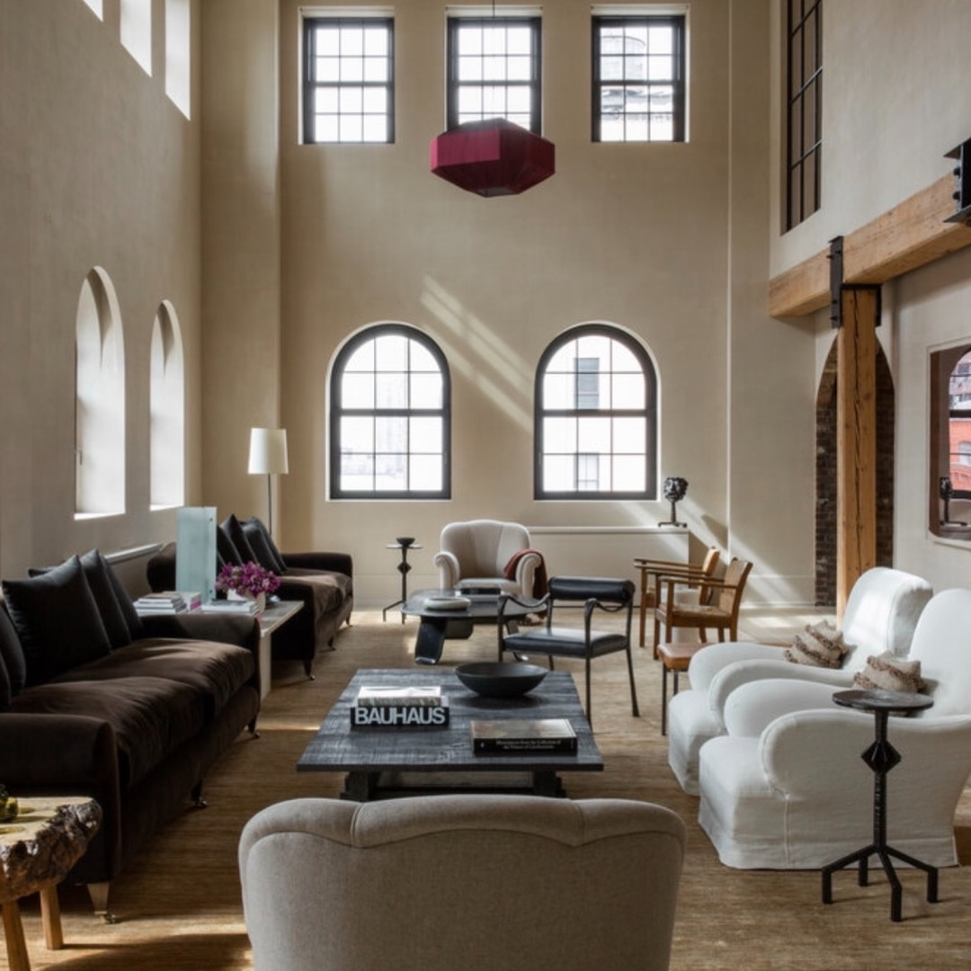 a living room filled with furniture and windows