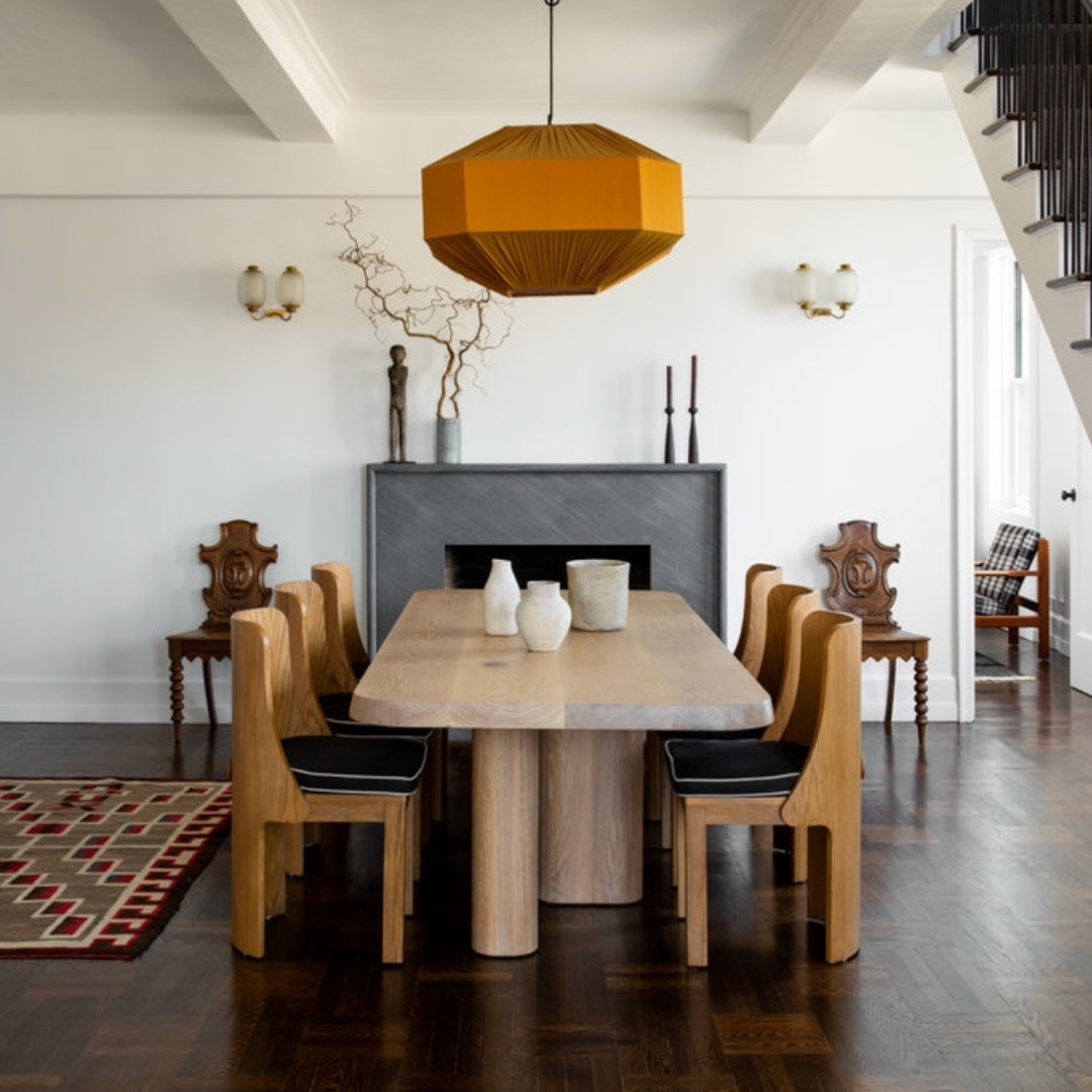 a dining room with a wooden table and chairs