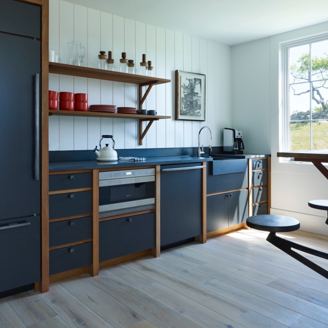 a kitchen with a stove, sink, and refrigerator