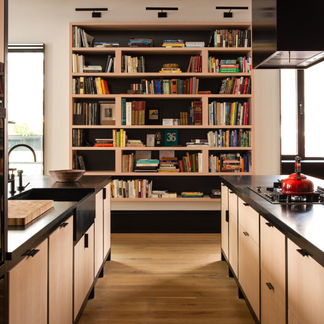 a kitchen with a lot of books on the shelves