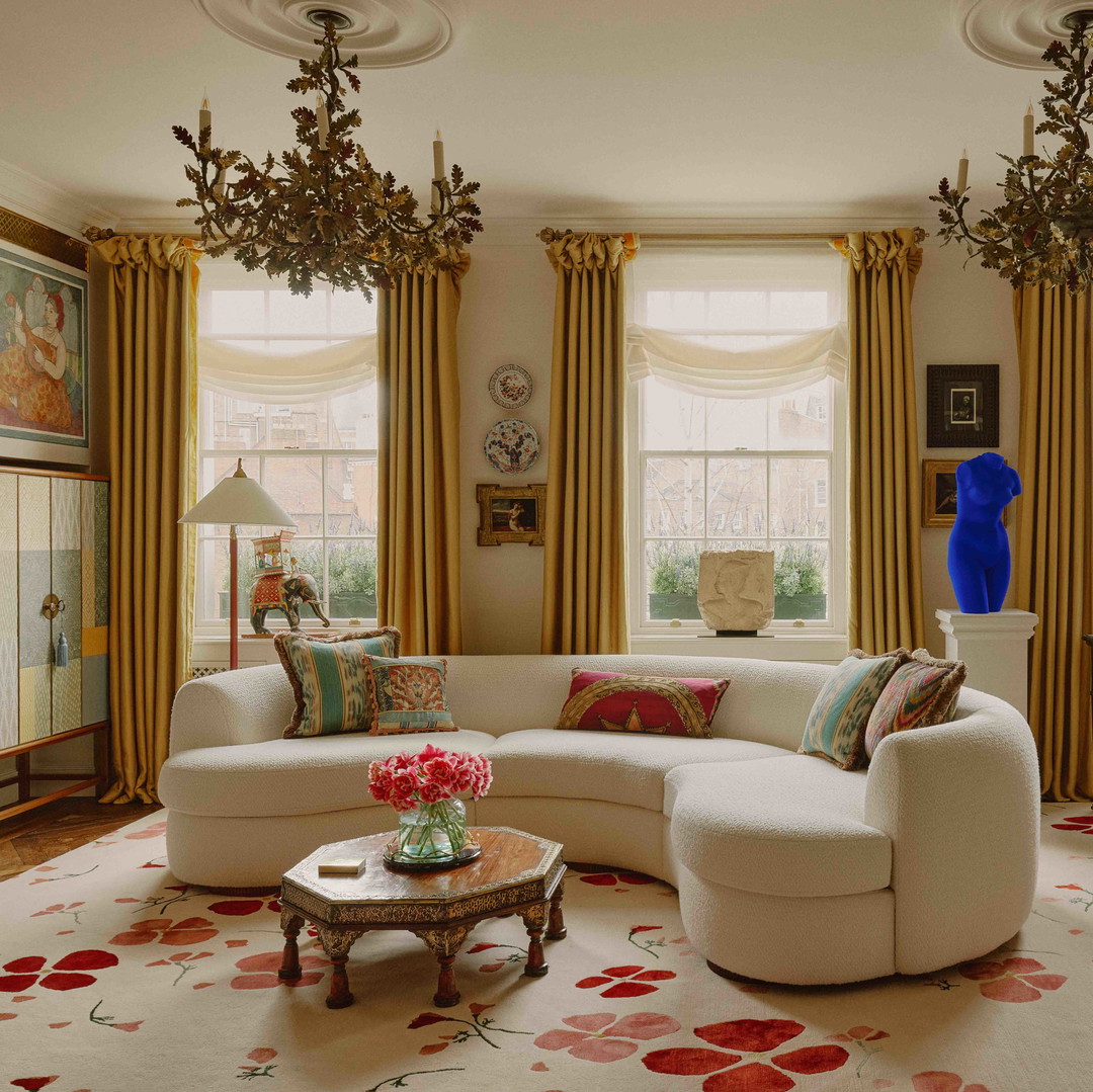 a living room filled with furniture and a chandelier