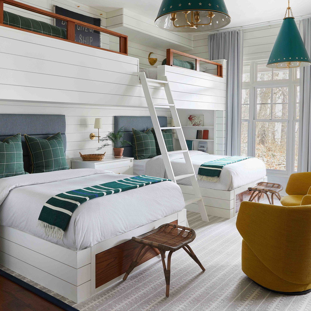 a bedroom with bunk beds and a ladder