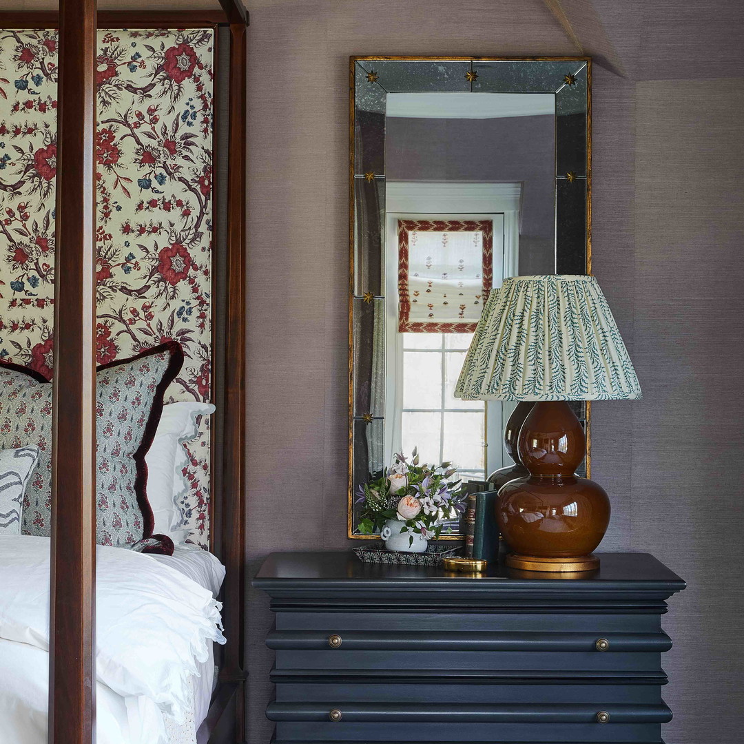 a bedroom with a canopy bed and a night stand