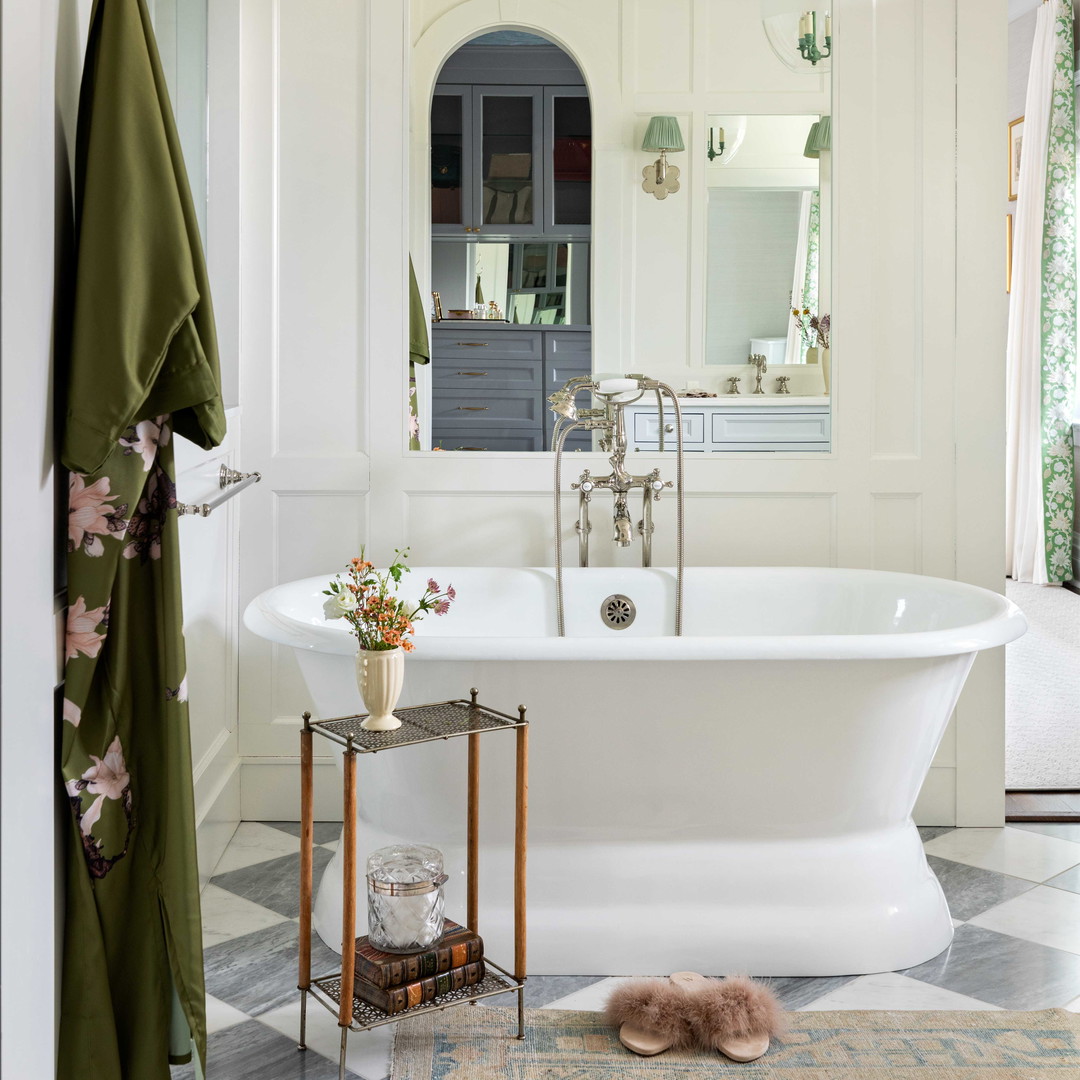 a bathroom with a claw foot tub and a rug