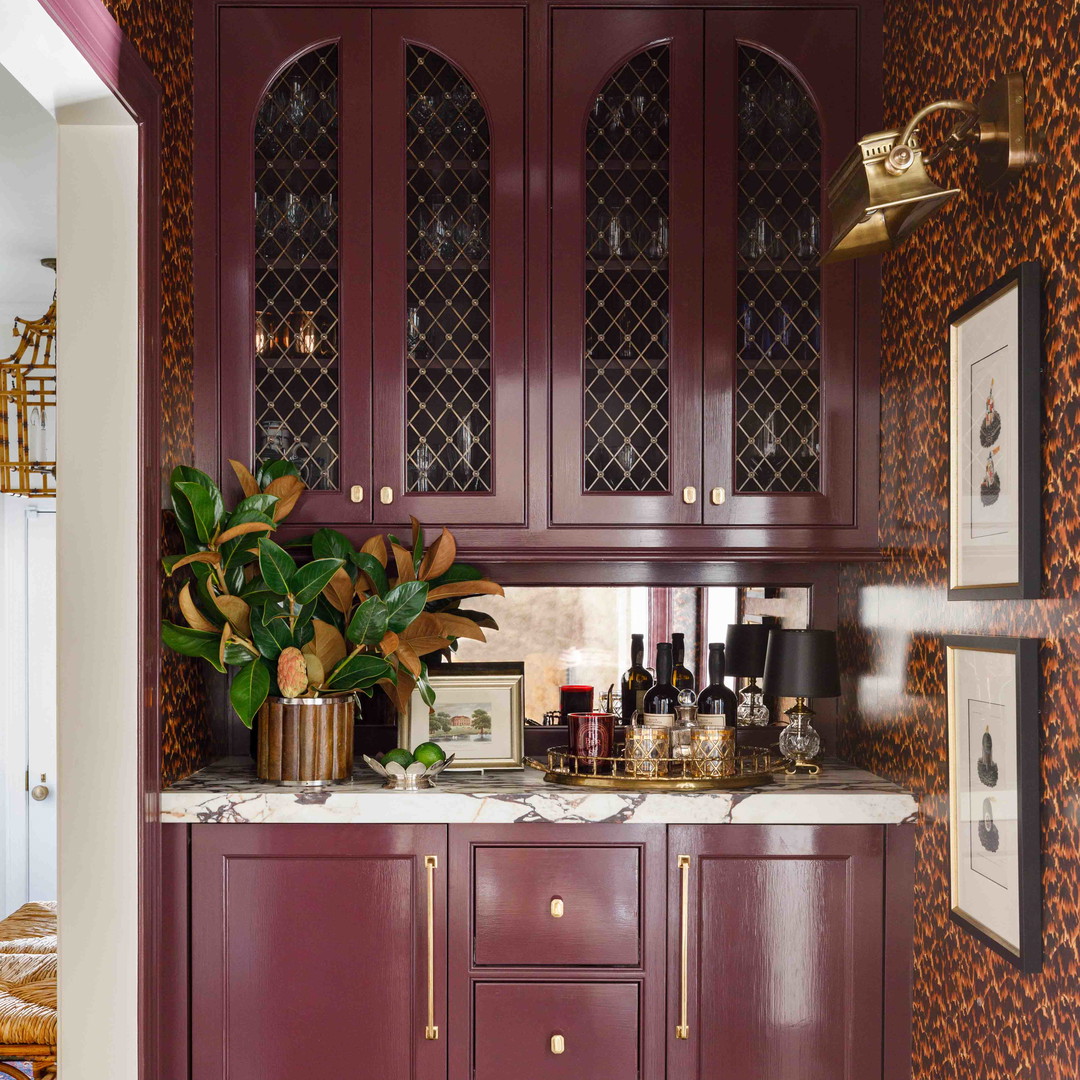 a kitchen with purple cabinets and a leopard print wallpaper