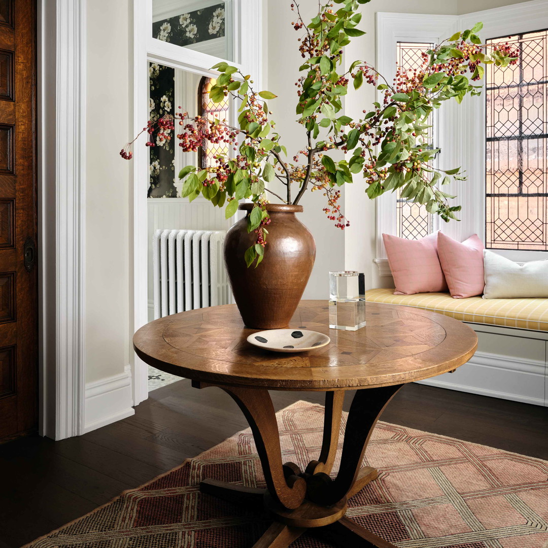 a table with a vase of flowers on top of it