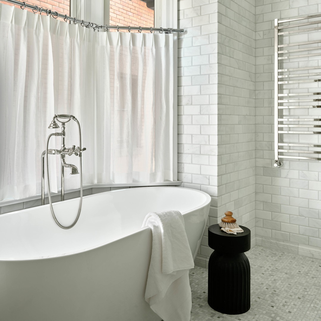 a white bath tub sitting next to a window