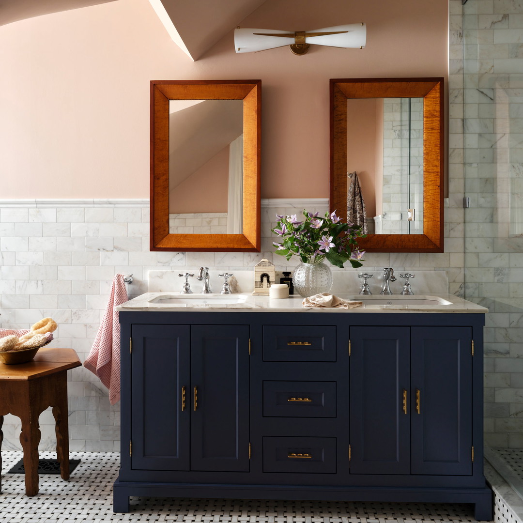 a bathroom with two sinks and a large mirror