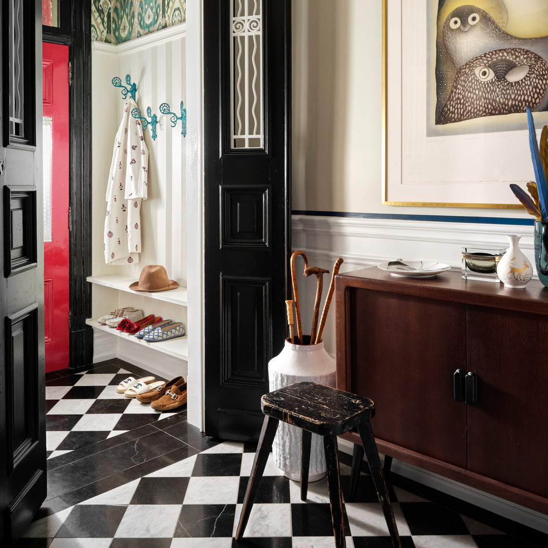 a room with a checkered floor and a black door