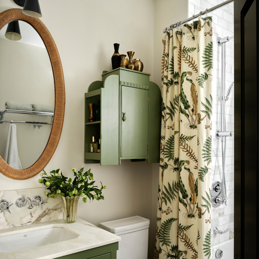 a bathroom with a green cabinet and a white toilet