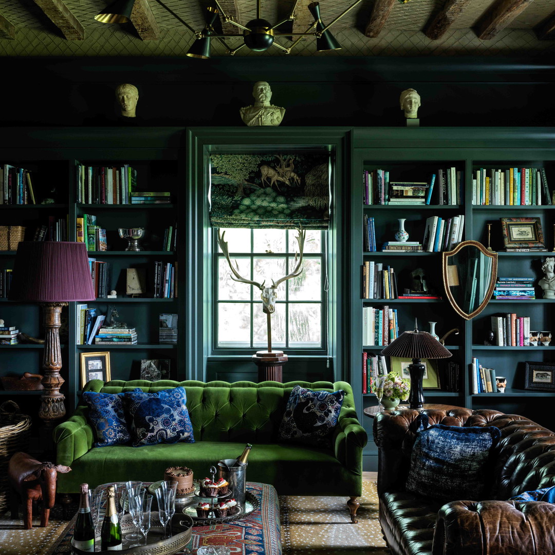 a living room filled with furniture and a green couch