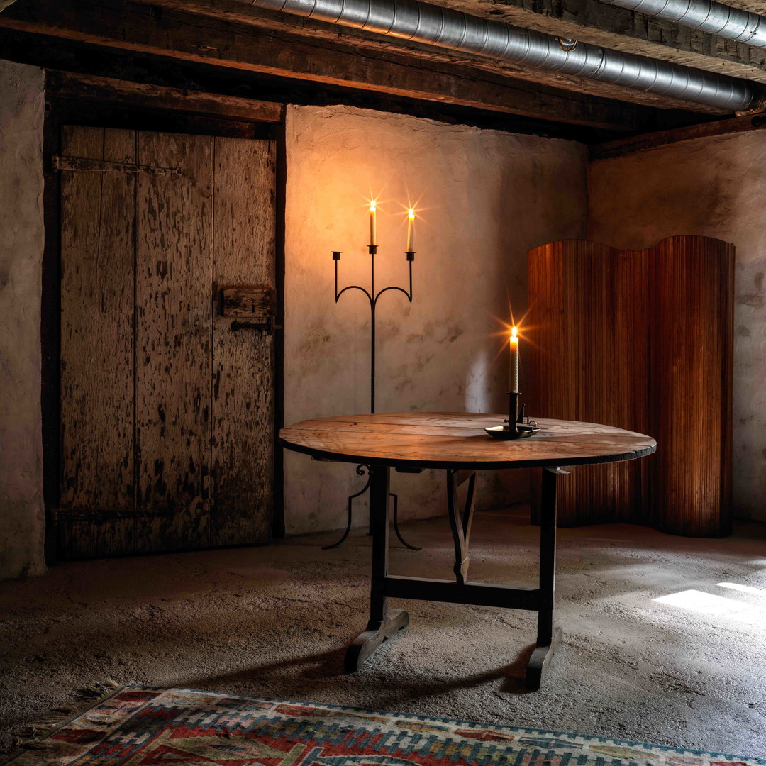 a table with three candles on it in a room