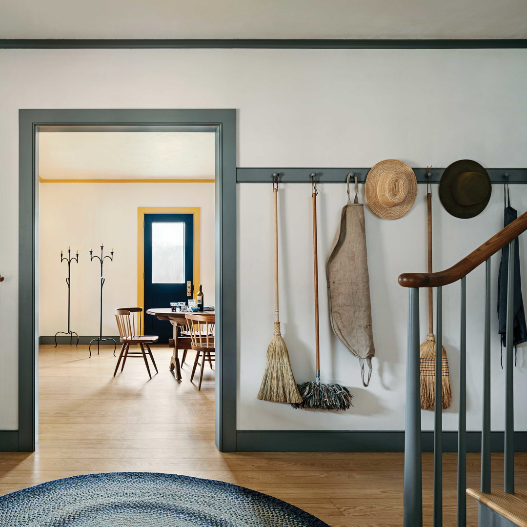 a hallway with a wooden floor and a blue rug