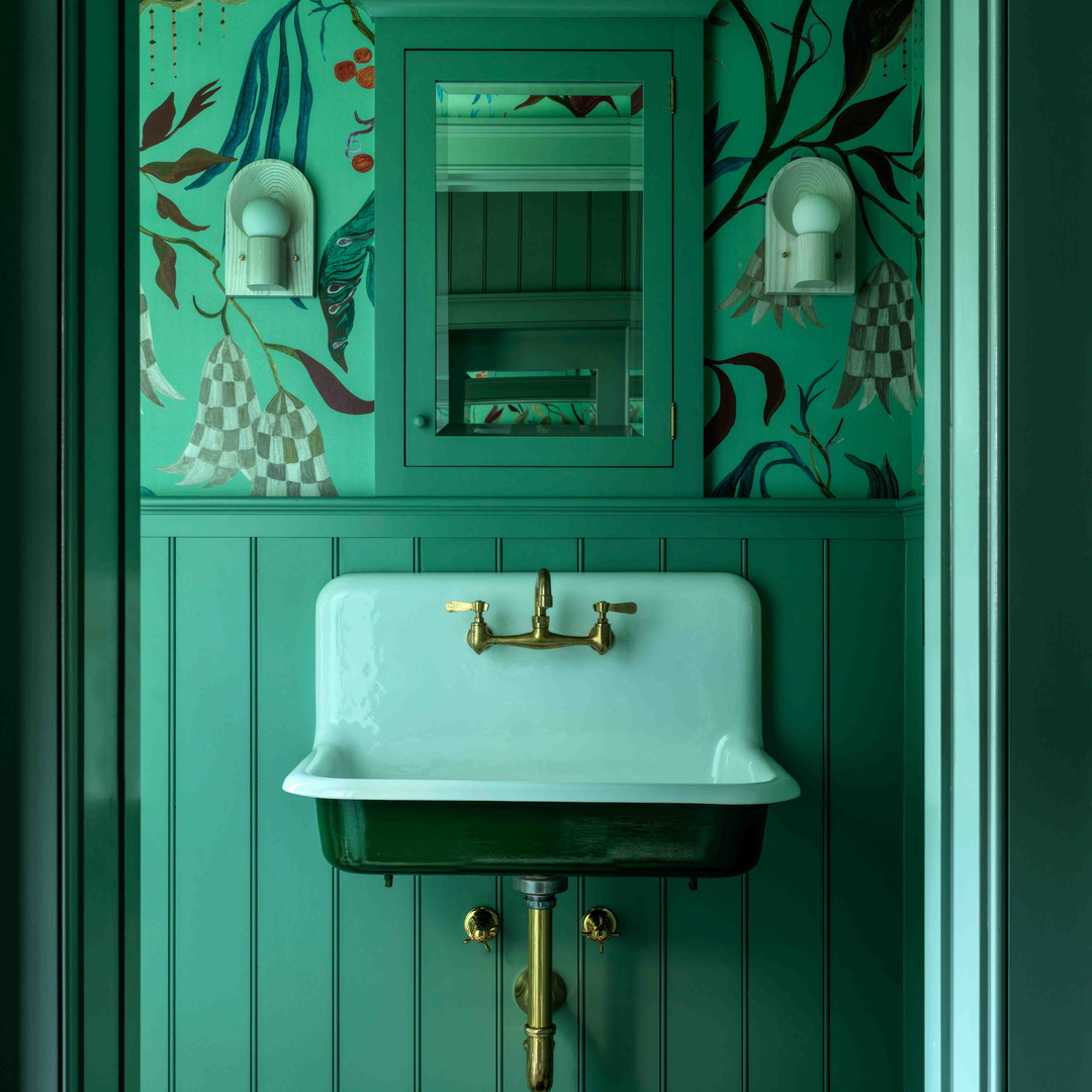 a bathroom with green walls and a white sink