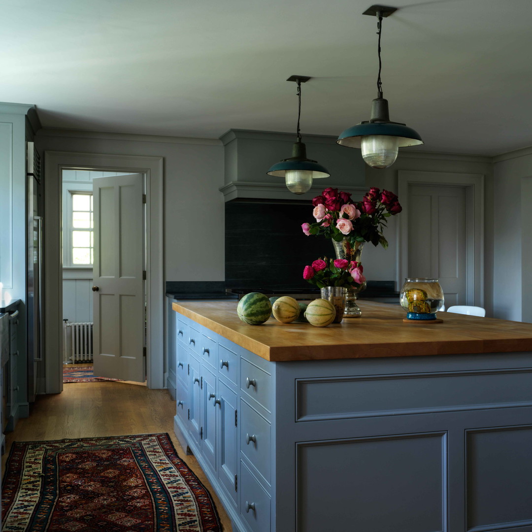 a kitchen with a center island with flowers on it