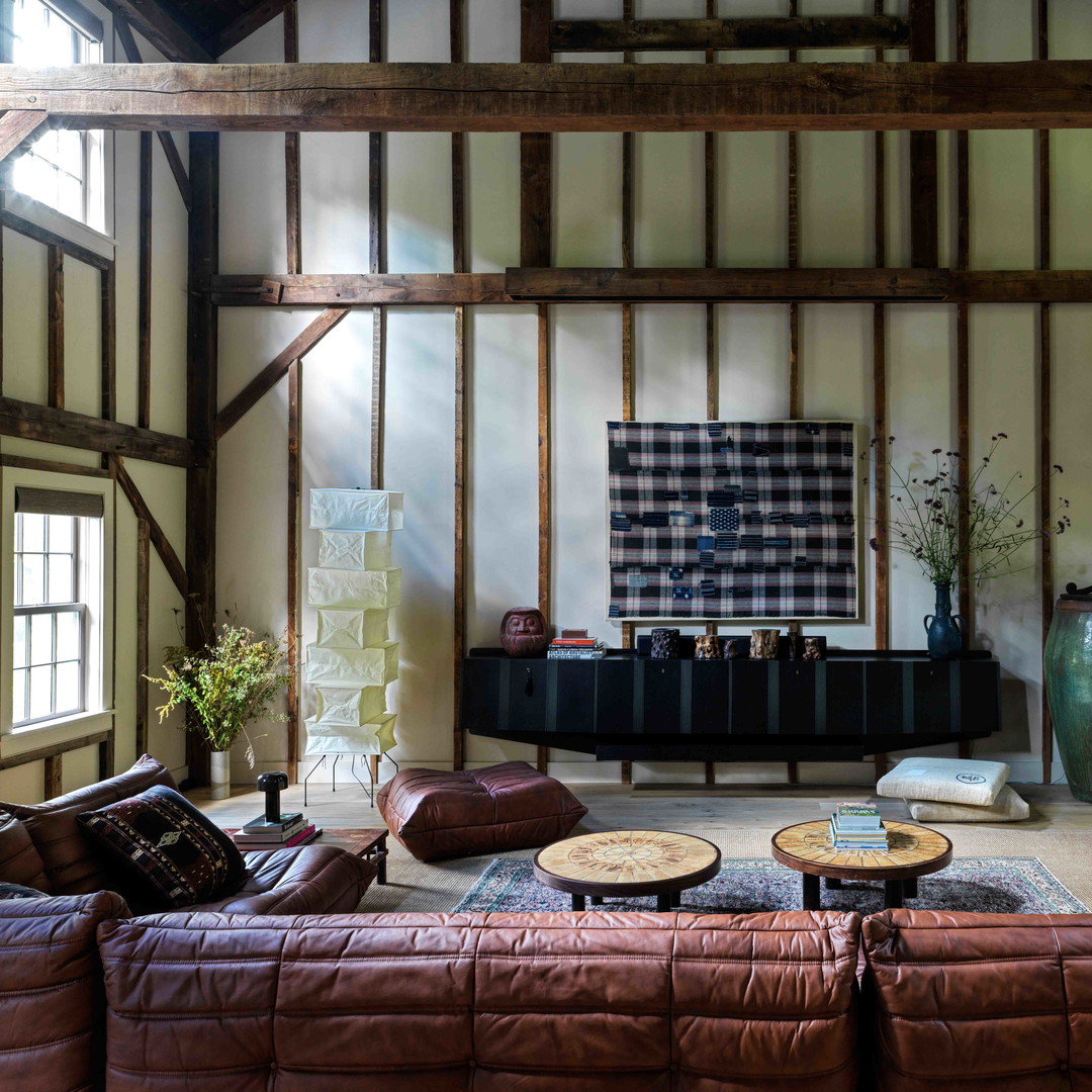 a living room filled with furniture and a painting on the wall