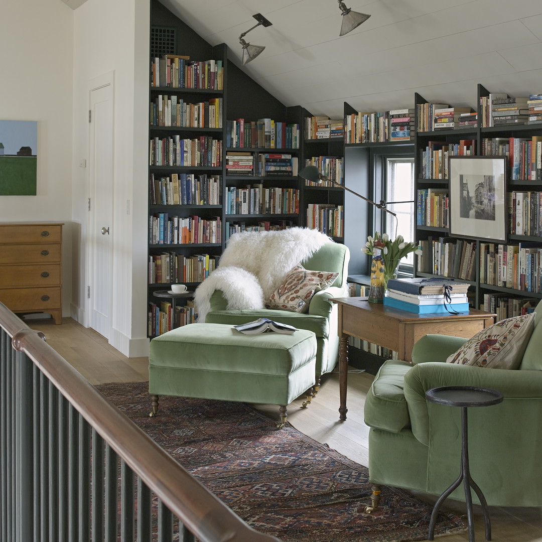 a living room filled with furniture and a book shelf