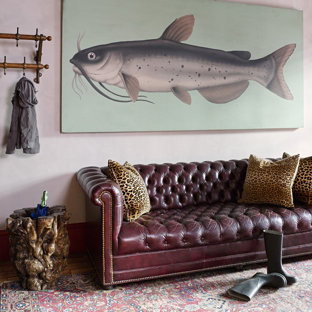 a living room with a couch and a painting on the wall