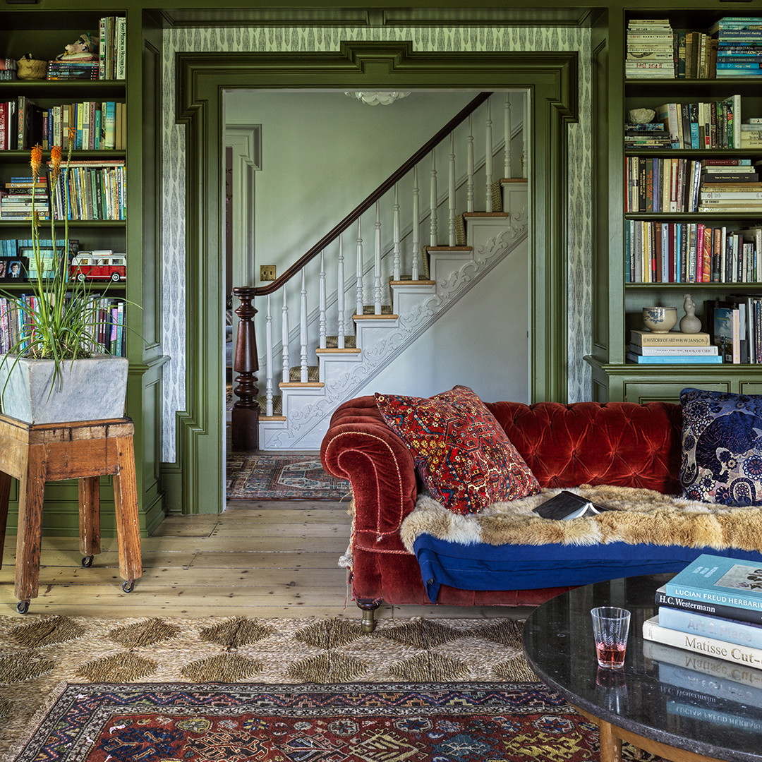 a living room filled with furniture and a staircase