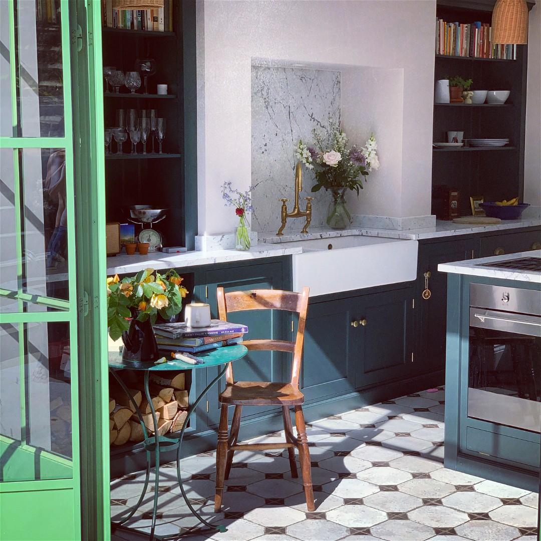 a kitchen with green cabinets and a table