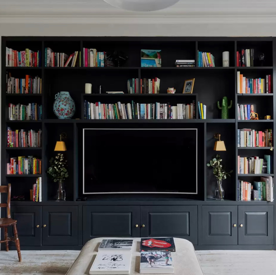 a living room with bookshelves and a television