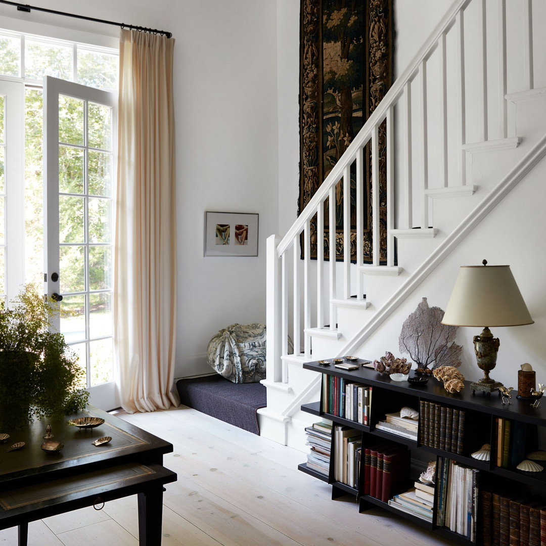 a living room filled with furniture and a stair case