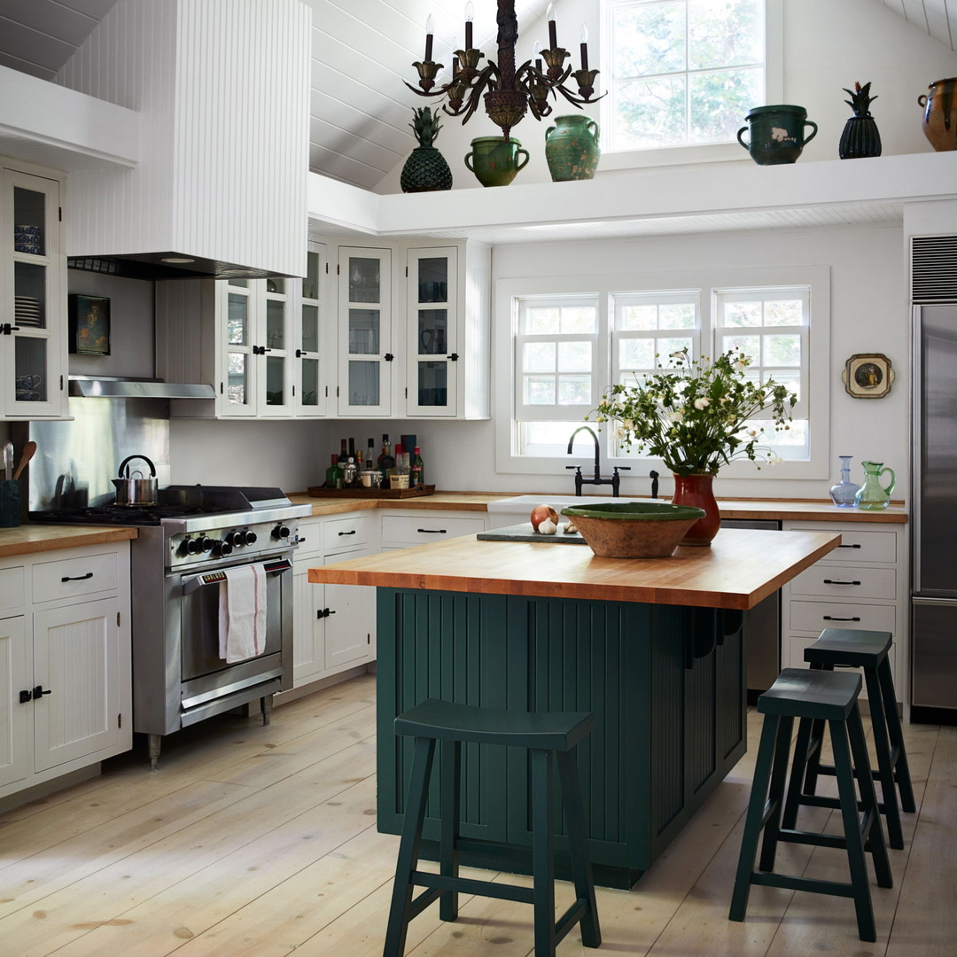 a kitchen with a center island with stools