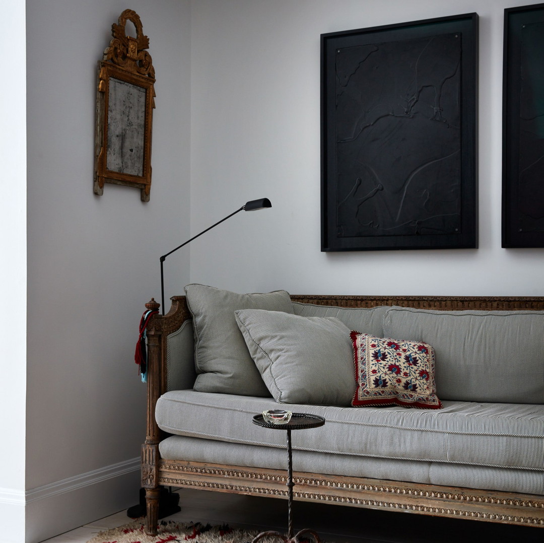 a living room with a couch and a lamp