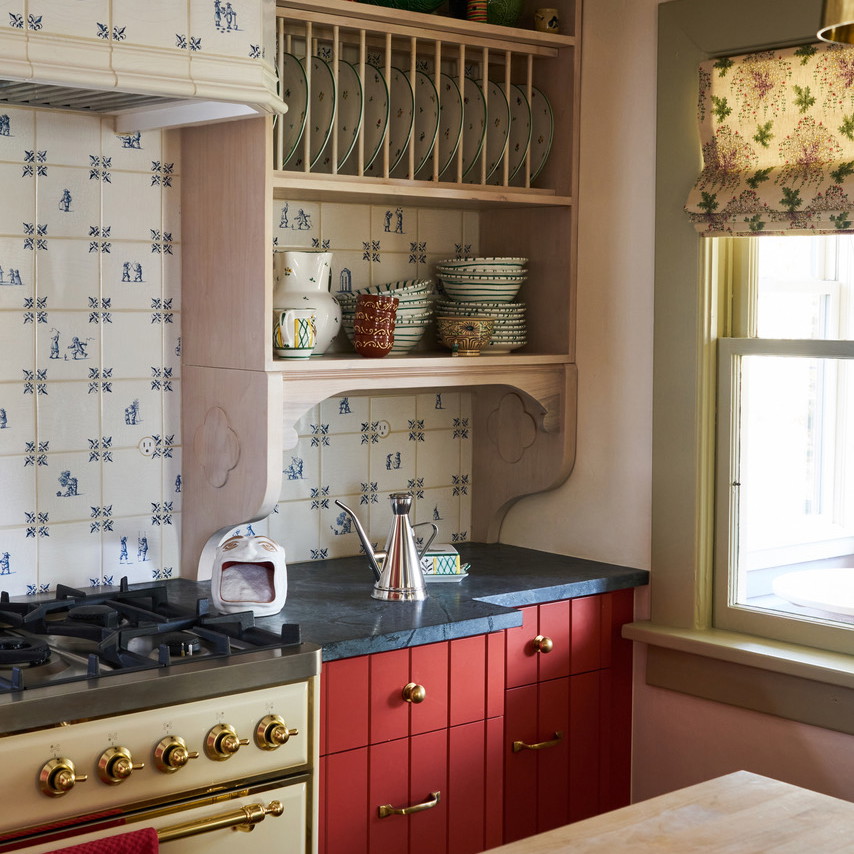 a kitchen with a stove top oven next to a window