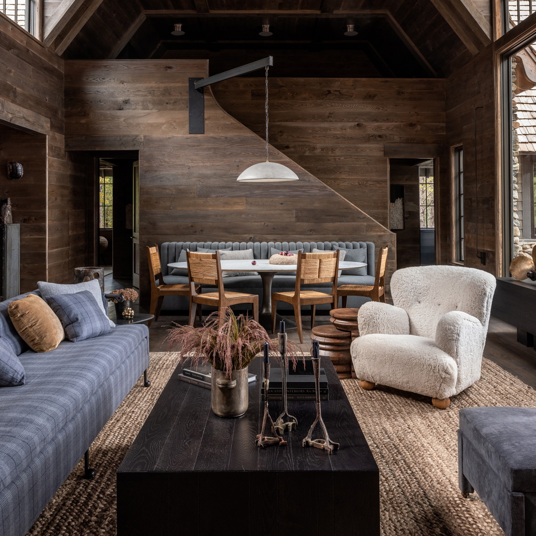 a living room filled with furniture and wooden walls