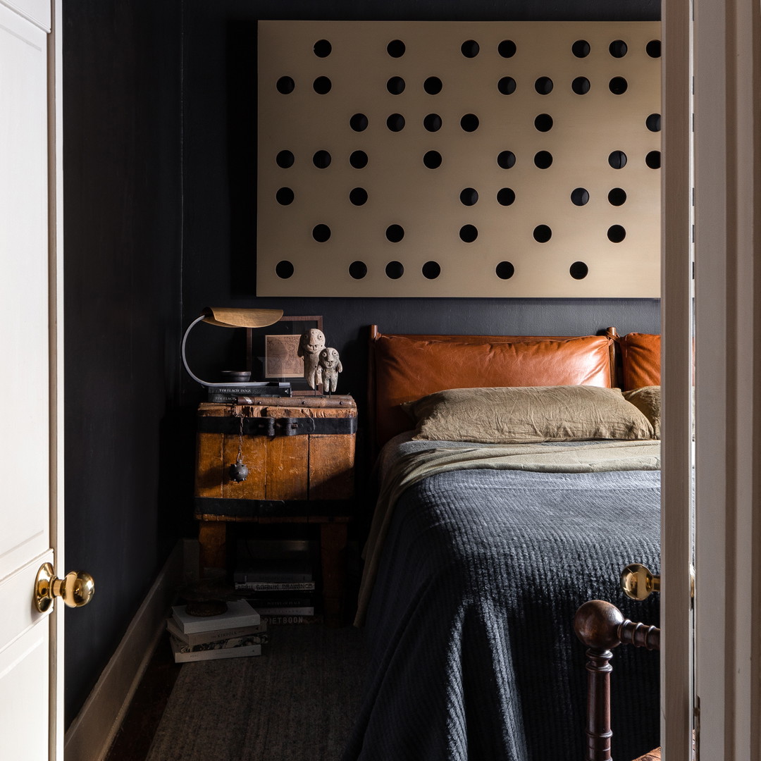 a bedroom with a bed and a dresser