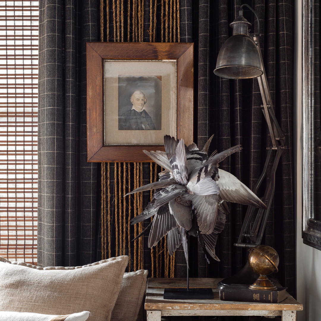 a living room filled with furniture and a painting on the wall