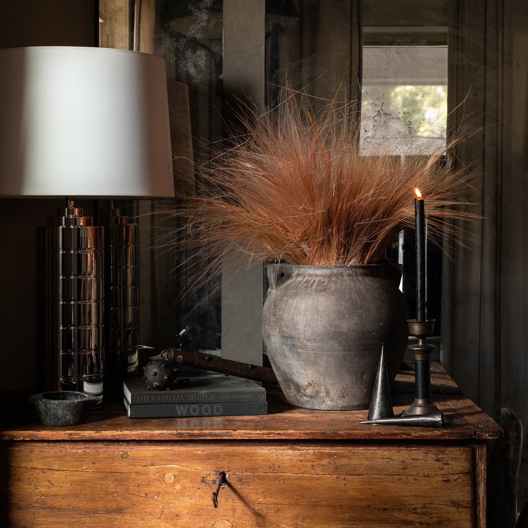 a table with a lamp and a vase on it