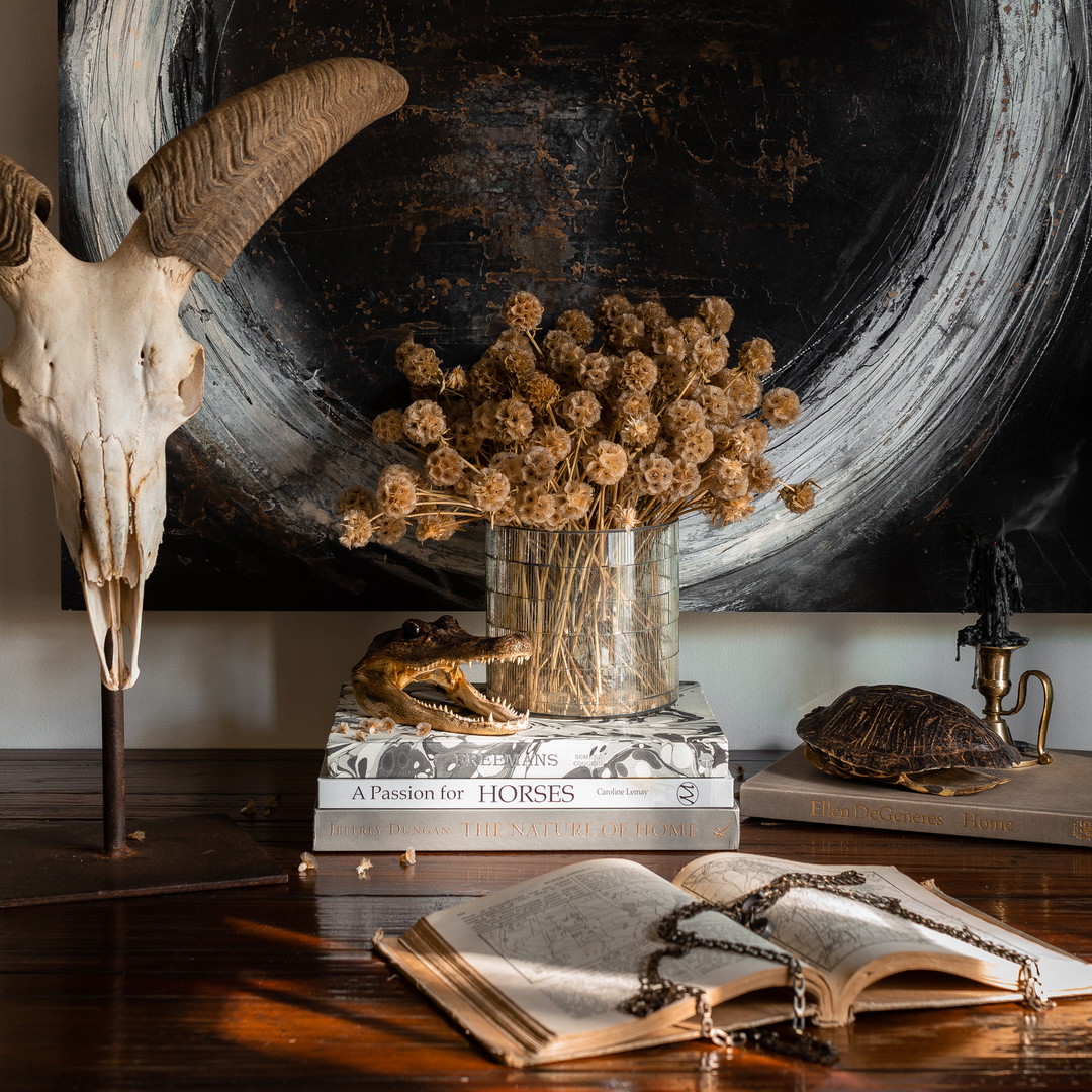 a table with a vase of flowers and a book on it