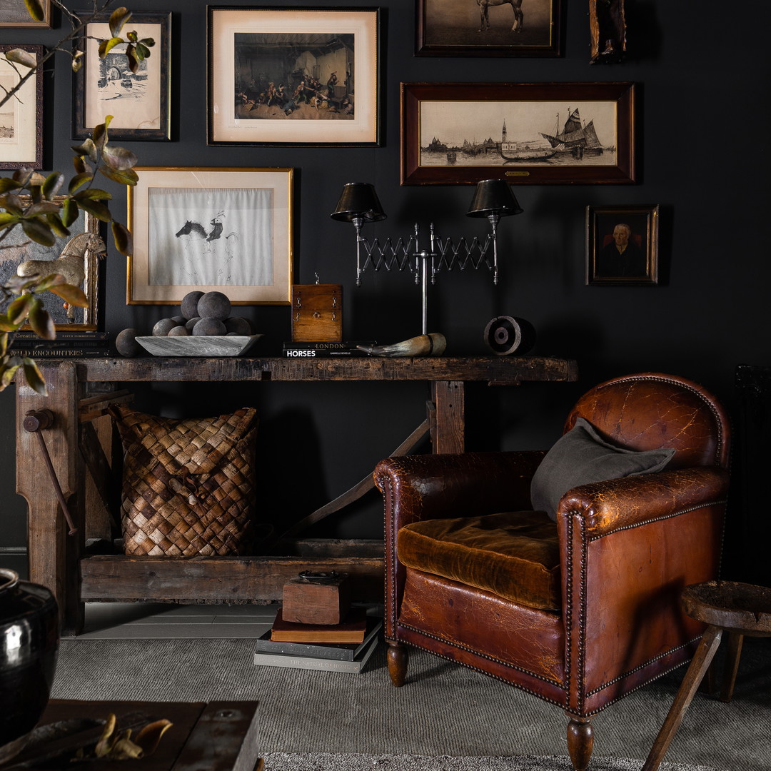 a living room filled with furniture and pictures on the wall