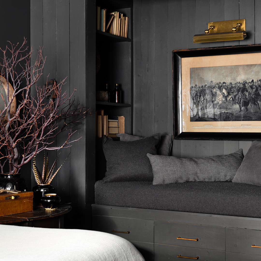 a room with a couch and a book shelf