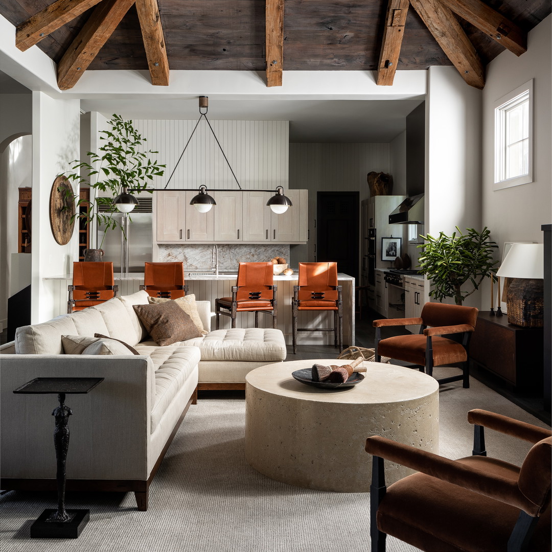 a living room filled with furniture and a wooden ceiling