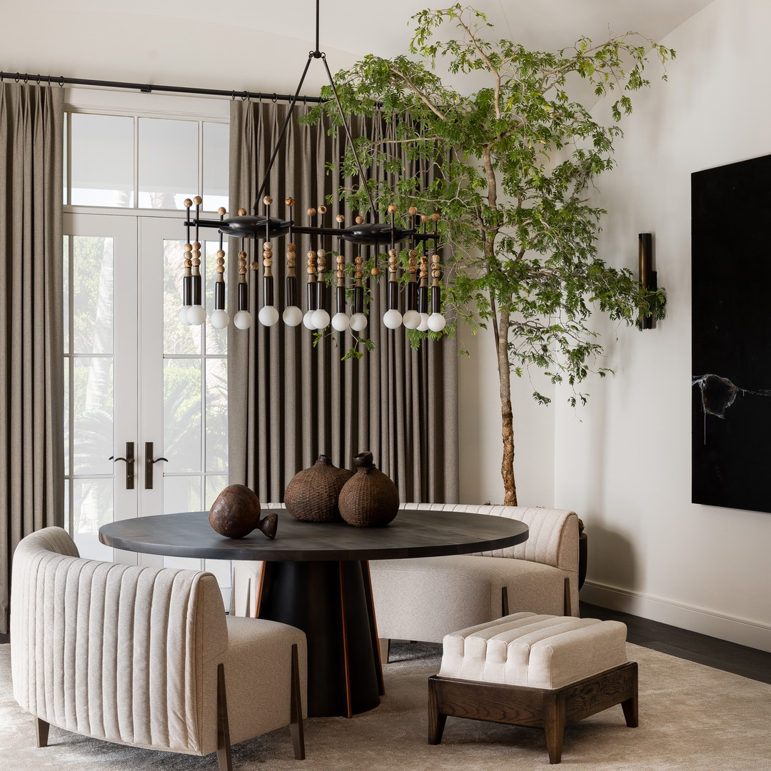 a dining room with a round table and chairs