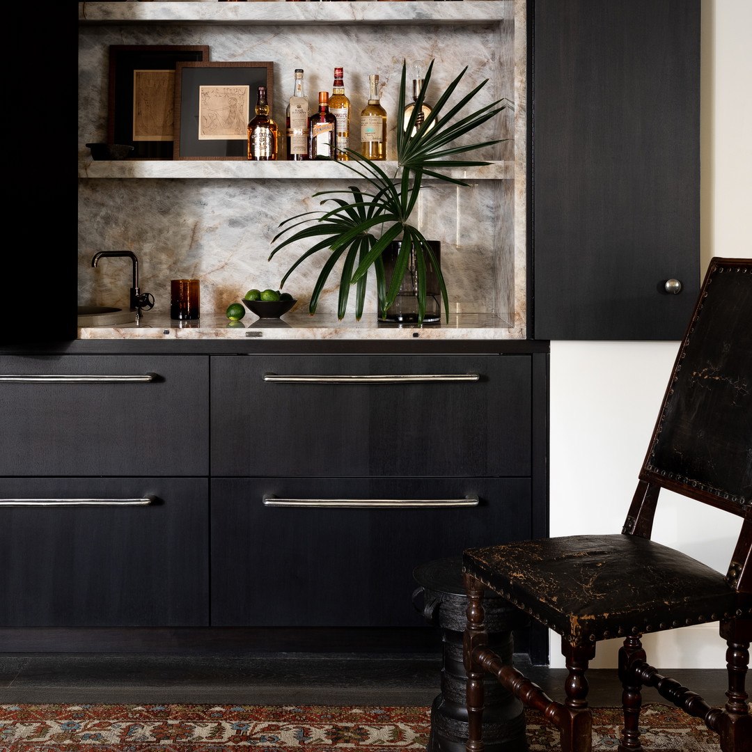 a room with a chair, shelves and a potted plant