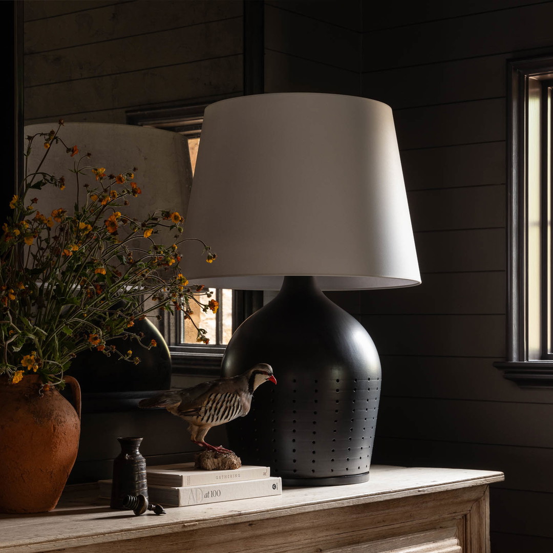 a table lamp sitting on top of a wooden dresser