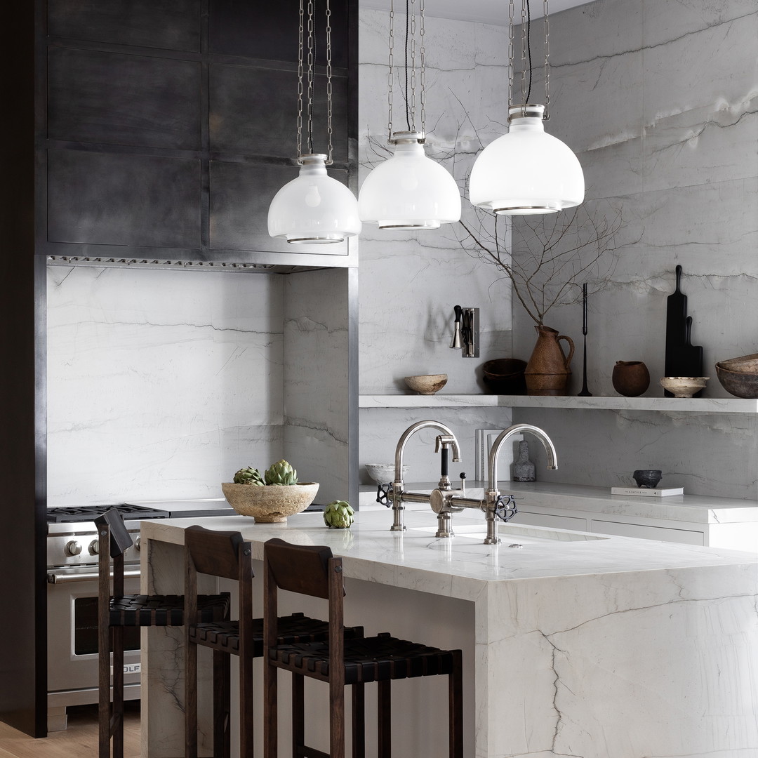 a kitchen with marble counter tops and a center island